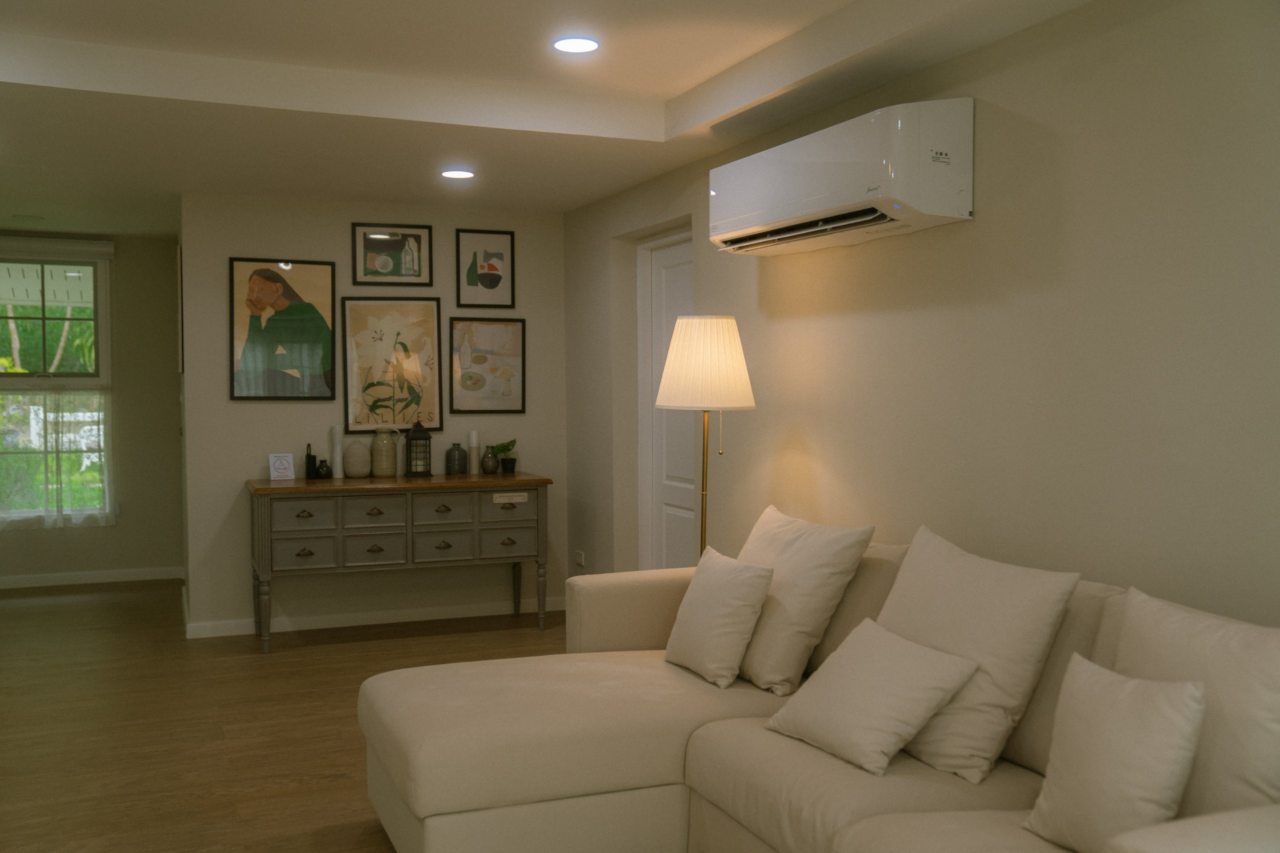 Living room with sectional sofa, print wall and sideboard